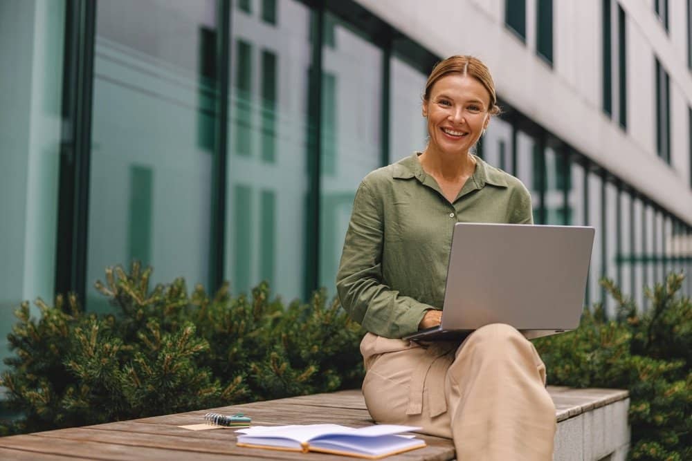 Woman,Analyst,Working,With,Documents,And,Use,Laptop,Sitting,Outside